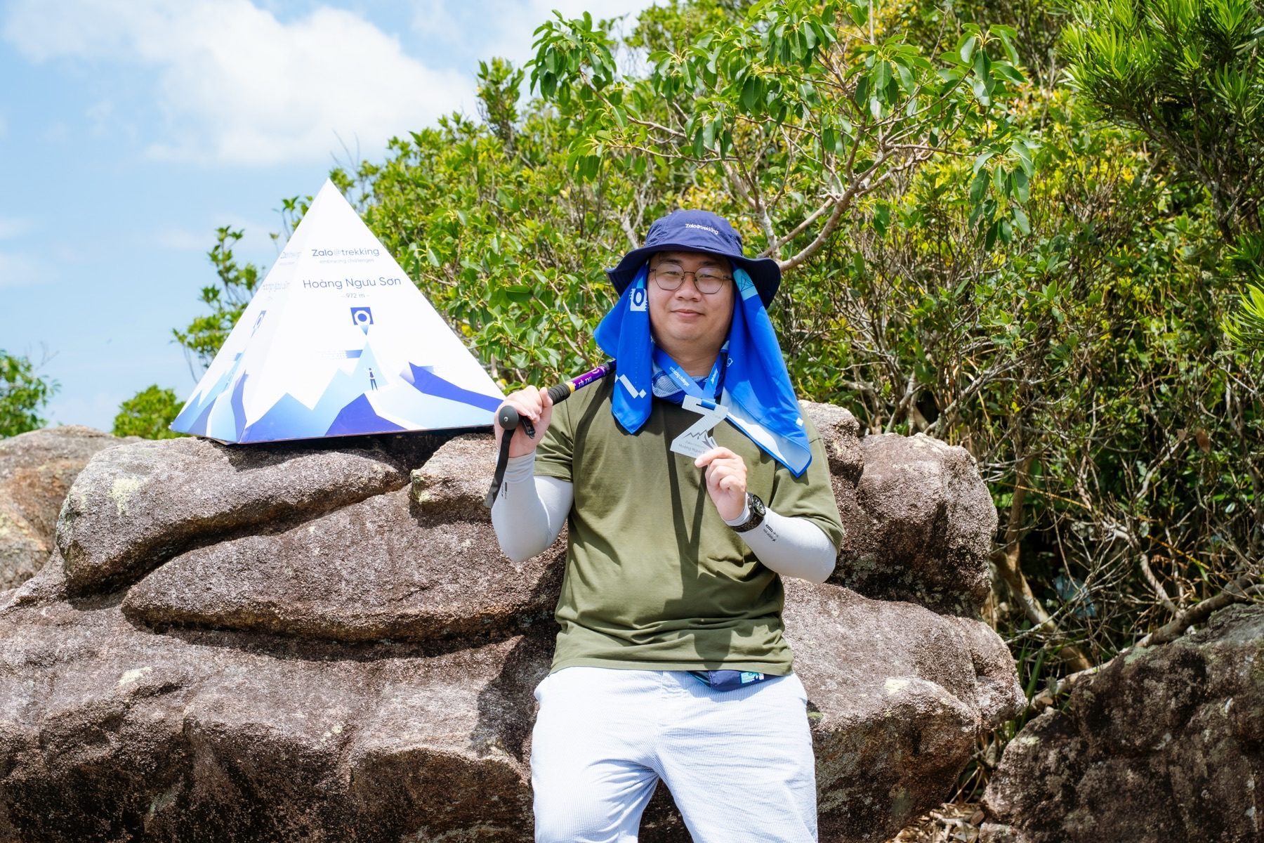Nguyen Le Phong taking a calm portrait at the trekking marker