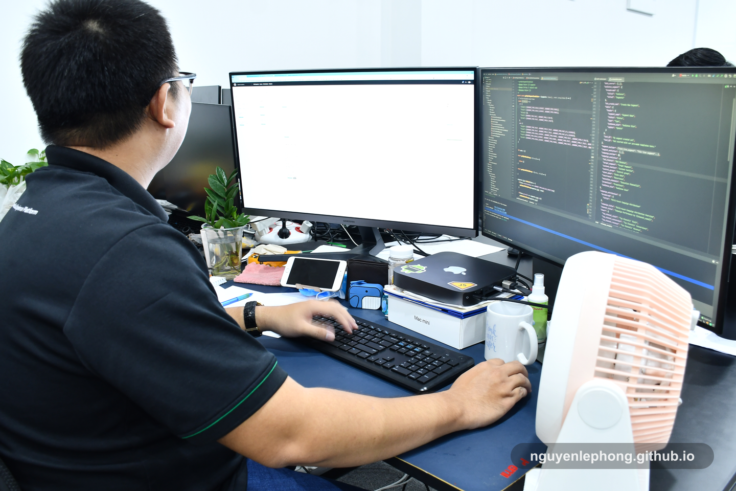 Nguyen Le Phong works at a dual-monitor desk where planning signals and implementation details sit close to the same piece of work.