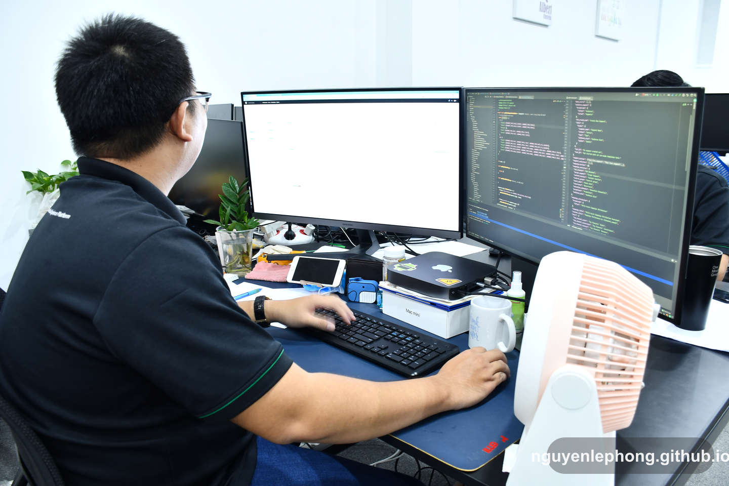 Nguyen Le Phong sits at a workstation with code and notes open, pausing before turning a sharp observation into a useful response.