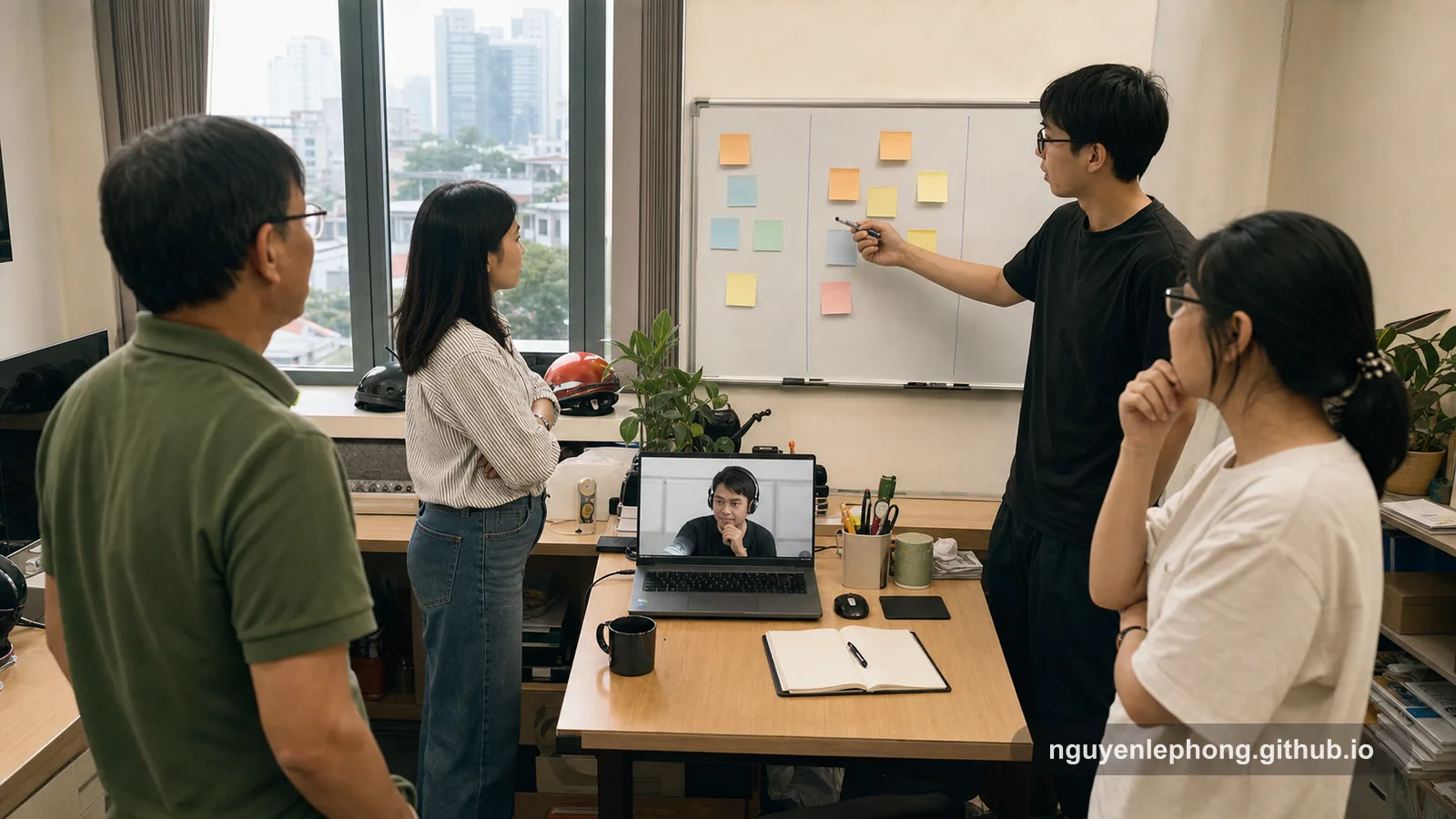 A small software team gathers in a modest morning office while one teammate joins by laptop video, using the standup to look at flow and blockers instead of repeating yesterday's updates.