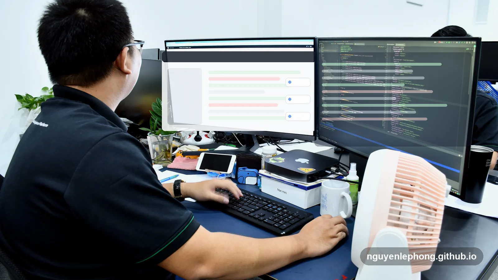 Nguyen Le Phong reviews code at a dual-monitor desk before sending a pull request for review.
