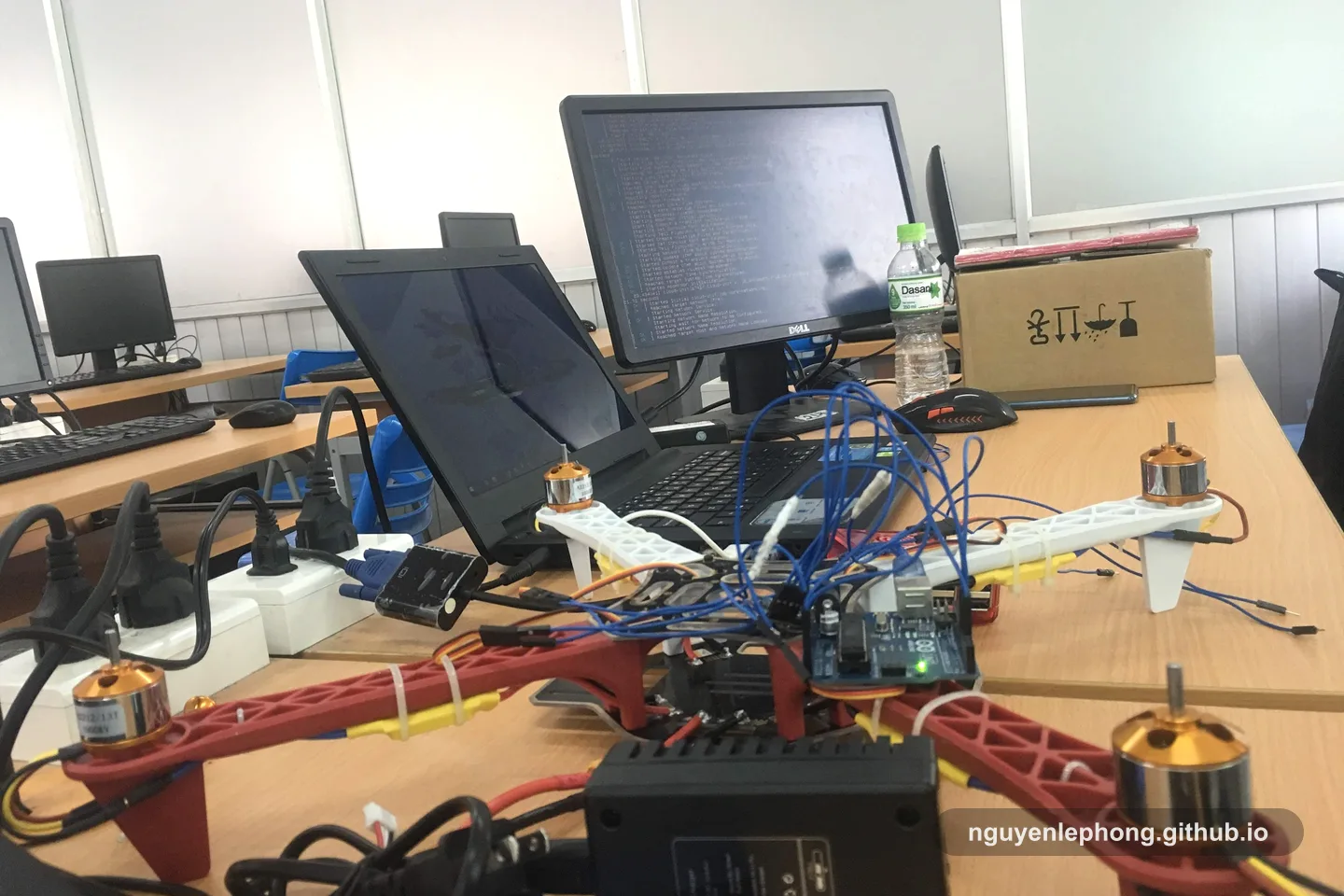 A small prototype sits half assembled on a lab bench beside a laptop and adapters, with each component still easy to trace.
